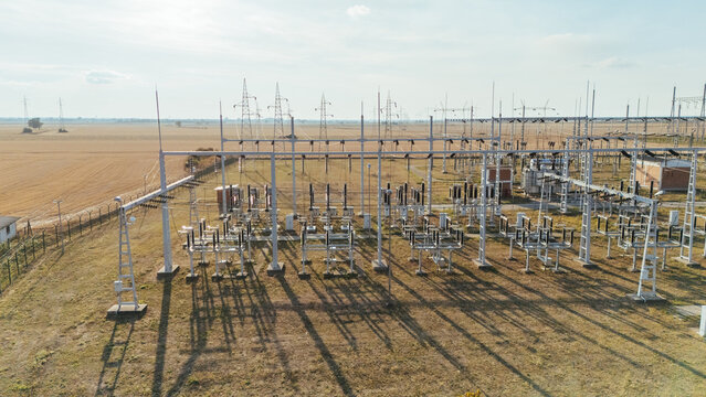 Aerial view of an electrical substation with high voltage power lines and transformers situated in a rural landscape in Sremska Mitrovica, Vojvodina, Serbia.