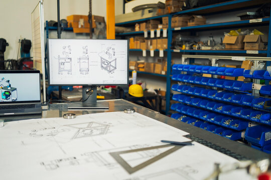 Engineering blueprints and computer models of automated machinery.