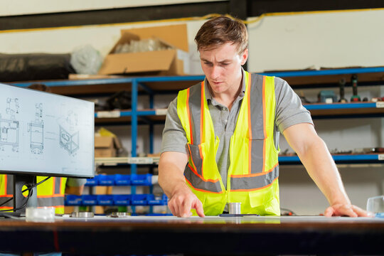 Factory Engineers Analyzing Precision Component During Industrial Inspection