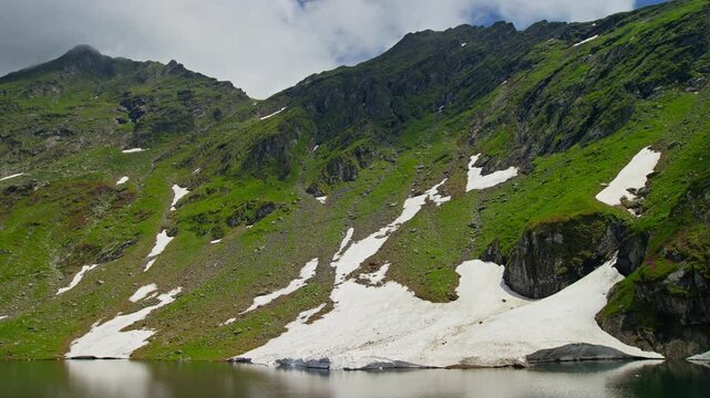 Quiet Balea Lake Beneath Snowy Fagaras Slopes