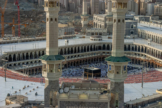 Aerial view of Masjid al-Haram featuring the Kaaba surrounded by pilgrims, tall minarets, and expansive marble courtyards in Makkah, Makkah Province, Saudi Arabia.