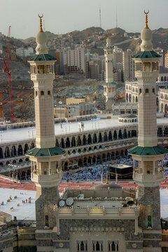 Aerial view of the Masjid al-Haram featuring the Kaaba and its towering minarets, with the urban landscape of Makkah in the background Makkah, Makkah Province, Saudi Arabia.