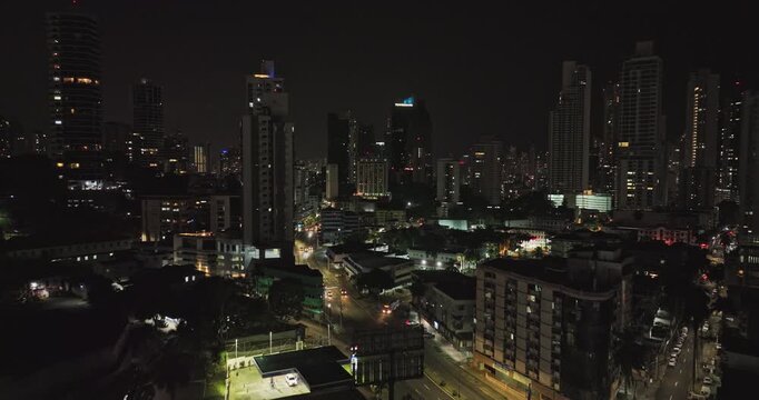 Panama City Aerial v89 low level flyover la cresta towards campo alegre neighborhoods surrounded by high rise buildings capturing downtown cityscape at night - Shot with Mavic 3 Cine - April 2022