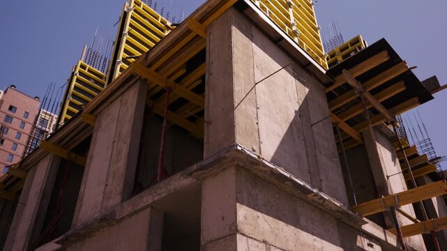 Concrete building structure with yellow slab formwork under construction