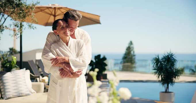 Couple, relax and smile at resort with hug, bonding and partner on anniversary and holiday. Embrace, vacation and happy mature people on getaway with love, commitment and honeymoon by hotel pool