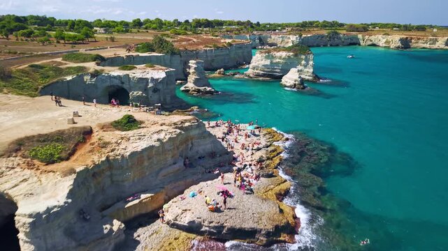 Aerial view of Faraglioni di Sant'Andrea sea stacks in Puglia, Puglia, Italy