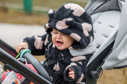 Baby in stroller looking away during outdoor walk