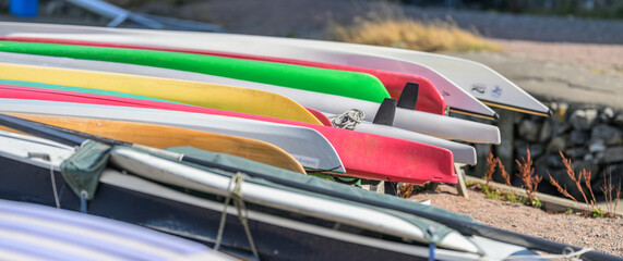 Layered colorful boat hulls create vibrant coastal pattern. © Trygve