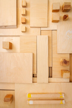 Flat lay of various wood and plywood pieces. Carpentry background.
