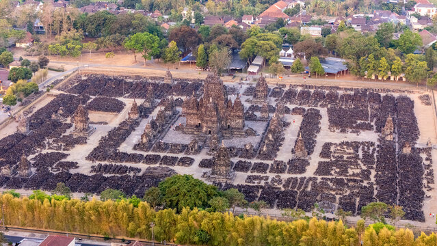 Aerial view of Sewu Temple, an ancient Buddhist temple complex with numerous small shrines surrounding a central main temple, set in Kecamatan Prambanan, Jawa Tengah, Indonesia.
