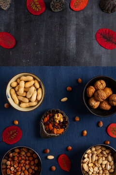 Food themed still life with crockery, various nuts and tea. Flat lay. Top view.