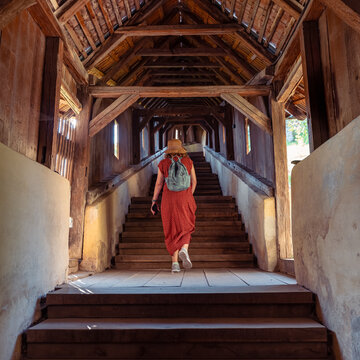 Woman walking up wooden covered staircase at Biertan fortified church in Transylvania Romania