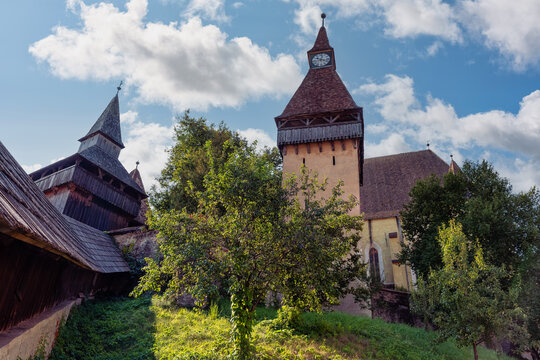 Biertan fortified church and historic clock tower surrounded by trees in Transylvania Romania