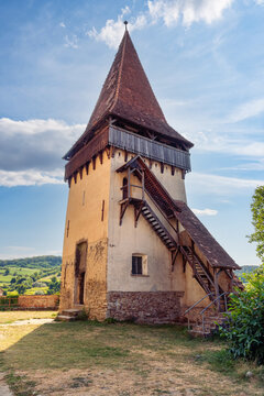 Historic defensive tower with exterior wooden staircase at Biertan fortified church Romania