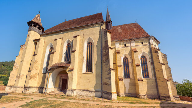 Gothic exterior of Biertan fortified church with tall arched windows in Transylvania Romania