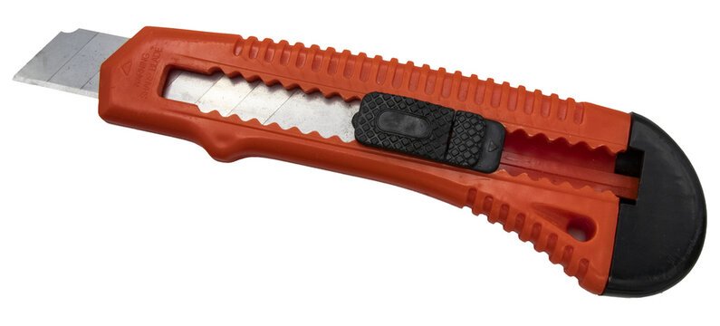 Orange utility knife with a retractable metal blade isolated on a clean white background