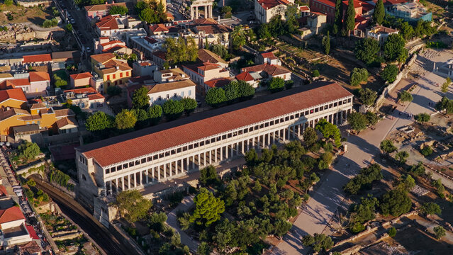 Aerial view of the Stoa of Attalos in the Ancient Agora of Athens, featuring its long colonnade, red-tiled roof, and surrounding archaeological ruins in Greece.