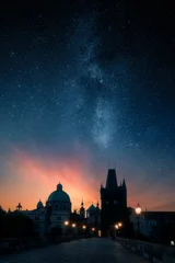 Charles Bridge and Old Town Bridge Tower under the Milky Way and starry night sky at twilight in Prague, Czech Republic © Jamo Images