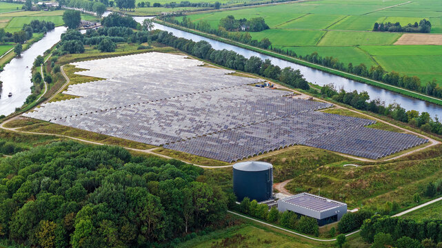 Aerial view of the solar thermal park in Dorkwerd ,Groningen, the Netherlands, showing large fields of solar panels and a circular thermal storage tank