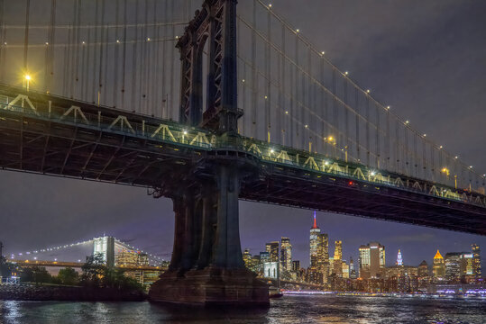 Manhattan Bridge with Brooklyn Bridge and Manhattan skyline at night