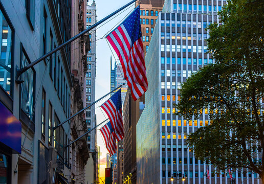 American flags on a Manhattan building facade at sunset