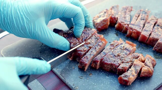 Chef Slicing Freshly Grilled Meat After Cooking