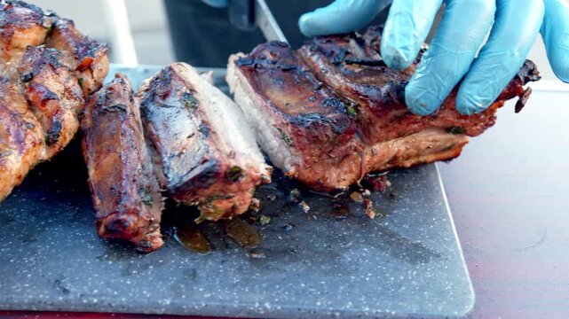 Chef Slicing Freshly Grilled Meat After Cooking