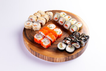 Assorted sushi rolls on wooden serving platter culinary arts food © Игорь Соколов