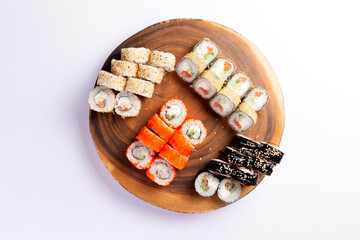 Assorted sushi rolls on wooden plate food preparation © Игорь Соколов