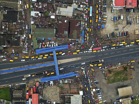 Aerial view of the busy Agege area featuring a prominent blue pedestrian bridge over a congested road with dense urban development and heavy traffic in Lagos, Lagos, Nigeria.