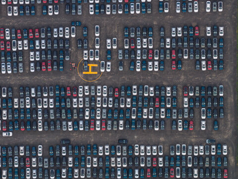 Aerial view of the SKODA Auto Volkswagen India Pvt Ltd car storage facility featuring rows of parked vehicles in Kharabwadi, Maharashtra, India.