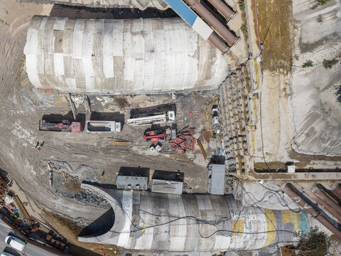 Aerial view of a large construction site featuring tunnel segments, heavy machinery, and earthworks in Istanbul, Istanbul, Turkey.