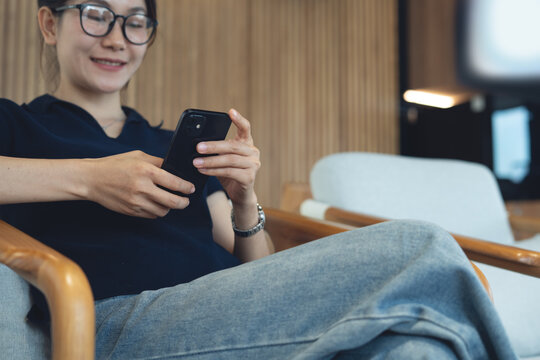 Asian woman smiling during using smartphone for social network at cafe, modern people lifestyle