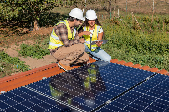 Engineers installing solar panels discussing sustainable energy project