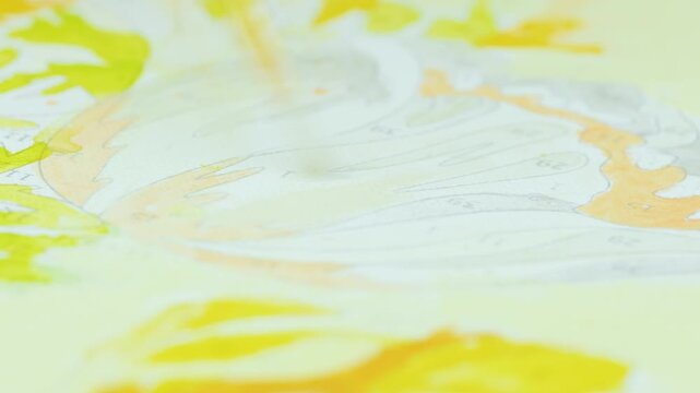 Close-up shot of a paintbrush applying paint to a numbered canvas creating a detailed artwork.