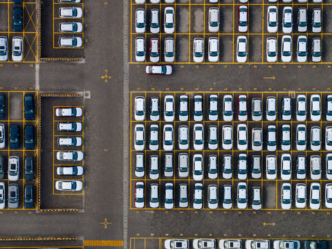 Aerial view of the SKODA Auto Volkswagen India Pvt Ltd parking lot filled with numerous new cars arranged in neat rows in Kharabwadi, Maharashtra, India.