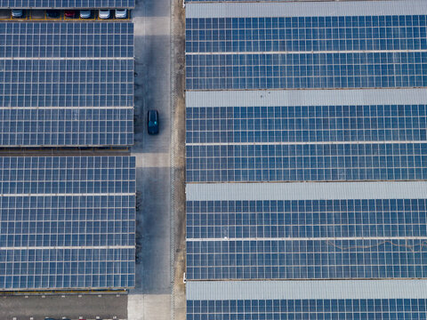 Aerial view of the extensive solar panel array installed on the rooftop of the SKODA Auto Volkswagen India Pvt Ltd facility in Kharabwadi, Maharashtra, India.