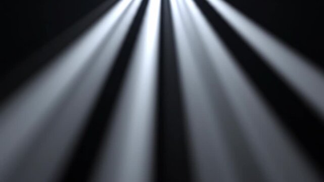 Stage spotlights beams illuminating darkness with cinematic motion and atmospheric haze for event opening