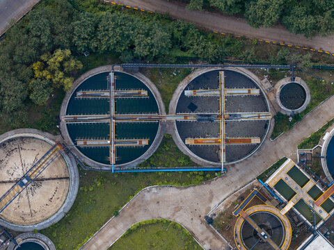 Aerial view of the Remondis ETP Plant featuring large circular sedimentation tanks, industrial infrastructure, and concrete pathways surrounded by lush greenery in Chakan, Maharashtra, India.