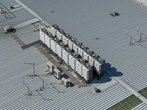 Aerial view of industrial HVAC units installed on a corrugated metal factory roof in Melbourne, VIC, Australia.