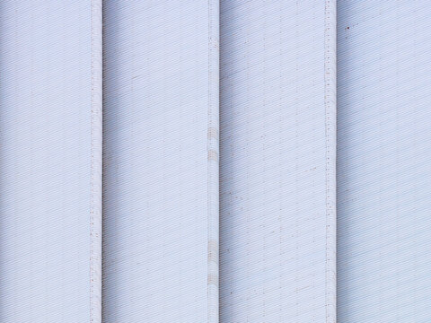 Aerial view of corrugated metal siding with repeating vertical lines and industrial texture in Chakan, Maharashtra, India.