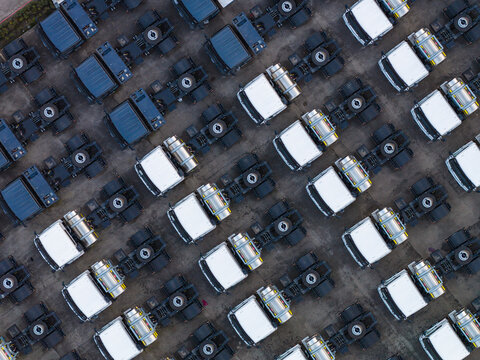 Aerial view of rows of parked trucks at the Blue Energy Motors facility in Mahalunge, Maharashtra, India.