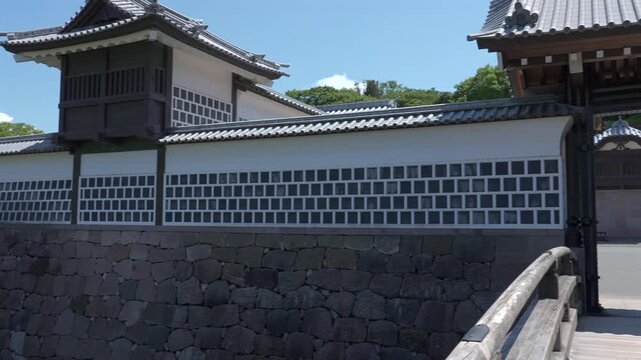 Ancient buildings, castle gate, moat and traditional stone walls of Kanazawa Castle, Japan.