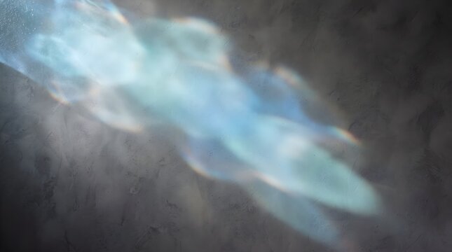Abstract blue glass texture illuminated by sunlight, producing soft translucent highlights, reflections, and atmospheric patterns.