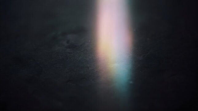 Abstract vertical light leak with soft rainbow highlights on a dark textured background, creating an atmospheric and cinematic visual effect.