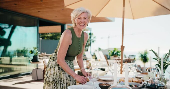 Face, food and host for home table setup with smile, snacks and prepare lunch for social event. Mature woman, healthy diet and happy on patio for gathering, party or catering in house backyard