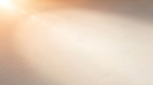 Warm golden sunlight flare spreading across a soft neutral surface, creating a luminous abstract background with an elegant atmospheric quality.