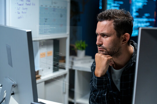 An overworked security engineer works in the blue glow of multiple monitors showing IDS alerts, log aggregation dashboards, and packet captures. He types rapid commands in the computer.