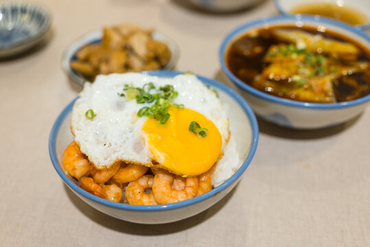Bowl of shrimp rice topped with fried egg and green onions