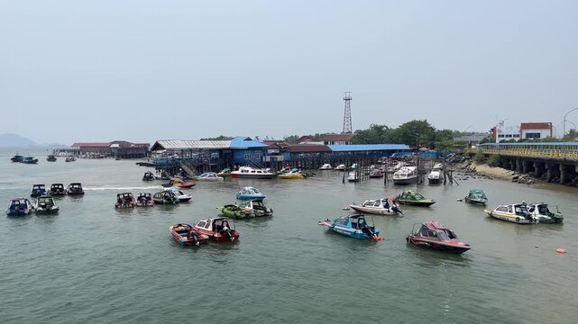 Busy harbor in Penajam Paser Utara with many speedboats waiting for passengers to Balikpapan near IKN Nusantara new capital of Indonesia